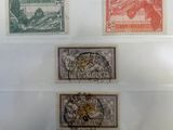 four different types of stamps on display in a glass case