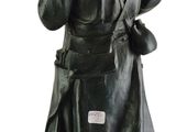 statue of a man with a gun in his hand on a white background