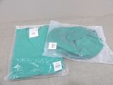 two bags of green shirts on the bed