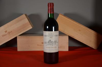 a bottle of wine sitting on a table next to two wooden boxes