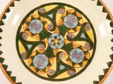a plate with a design on it on a white surface