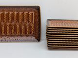 a stack of brown plates and a stack of brown plates