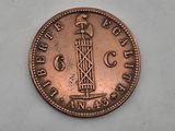 a close up of a coin with a tower on it