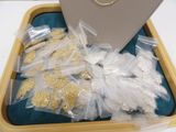 a box filled with gold and silver jewelry on a table
