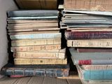 many books stacked on top of each other in a box