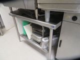 a stainless steel shelf with pots and pans on it