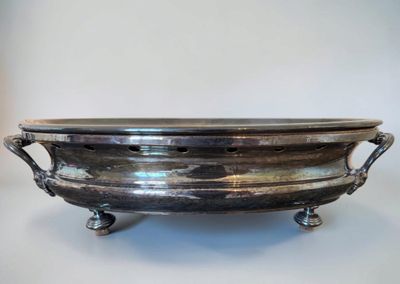 an antique silverplated footed bowl with handles and handles