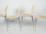 three chairs are lined up against a white wall in a room