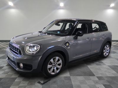 the mini countryman is parked in the garage on a checkered floor