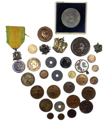 a lot of coins and medals on a white surface
