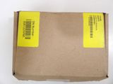 an open box with a yellow label on it sitting on a white surface