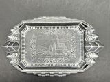 an old silver plate with a picture of a castle on it