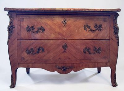 a wooden chest of drawers with a marble top