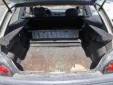 the back of a car with its trunk open and the back of the car in the back