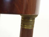 a close up of a chair with a wooden seat and legs