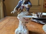 a figurine of a man playing a guitar on a table