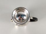 a silver ring with a reflection of a person in it