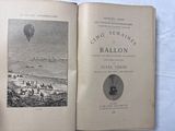 a book open on a bed with a picture of a hot air balloon in the sky