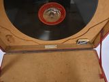 a red suitcase with a record inside of it