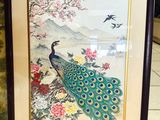 framed picture of a peacock sitting on a branch of a tree