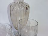 three wine glasses and a vase on the table