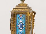 a blue and gold clock sitting on a table
