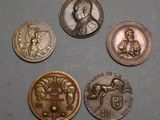 four different types of coins are shown on a gray surface