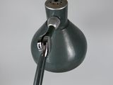 a green lamp that is on a table