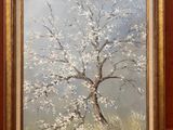 une peinture à l'huile représentant un arbre avec des fleurs blanches dans un cadre doré sur une surface rouge