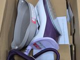 a box that has a purple and white iron in it