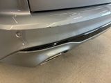 a close up of a car ' s bumper with a dent on it