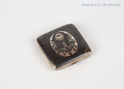 a small metal object with a picture on it