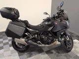 a motorcycle that is parked on a checkered floor