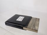 a black book sitting on top of a glass table