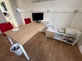 a desk with a computer and a printer on it in a room
