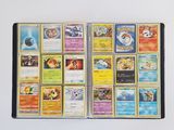 a lot of pokemon cards in a book on the table