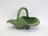 an image of a green ceramic basket with a handle on a white background