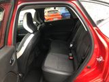 the back seat of a red car with the door open