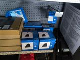 many boxes of electronic devices on the shelf in the store