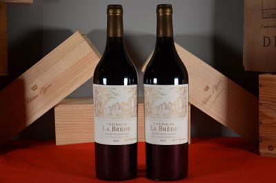 two bottles of wine sitting next to each other on a table