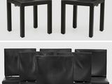 six black leather dining chairs with black legs and a white background