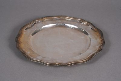 silver plate with scalloped edge on grey background