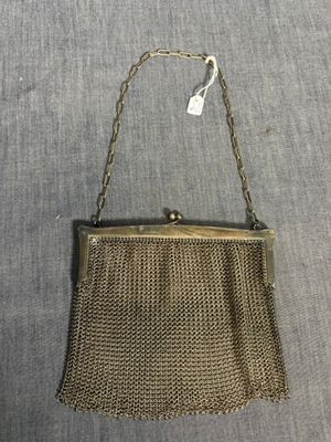 an old gold mesh purse with chain hanging from it