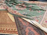 many different rugs laid out on the floor