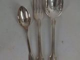 four silver spoons and two silver spoons on a table