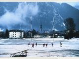 a group of people playing soccer on a snowy field