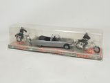 a close up of a toy car and motorcycle in a box