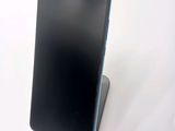 a phone that is sitting on a stand on a table