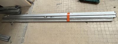 several pieces of metal are laying on the floor in a room