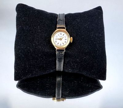 a watch that is sitting on top of a pillow